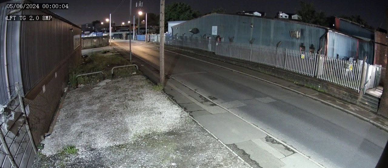 Night footage from a Uniview 8MP camera showing a clear, bright street scene